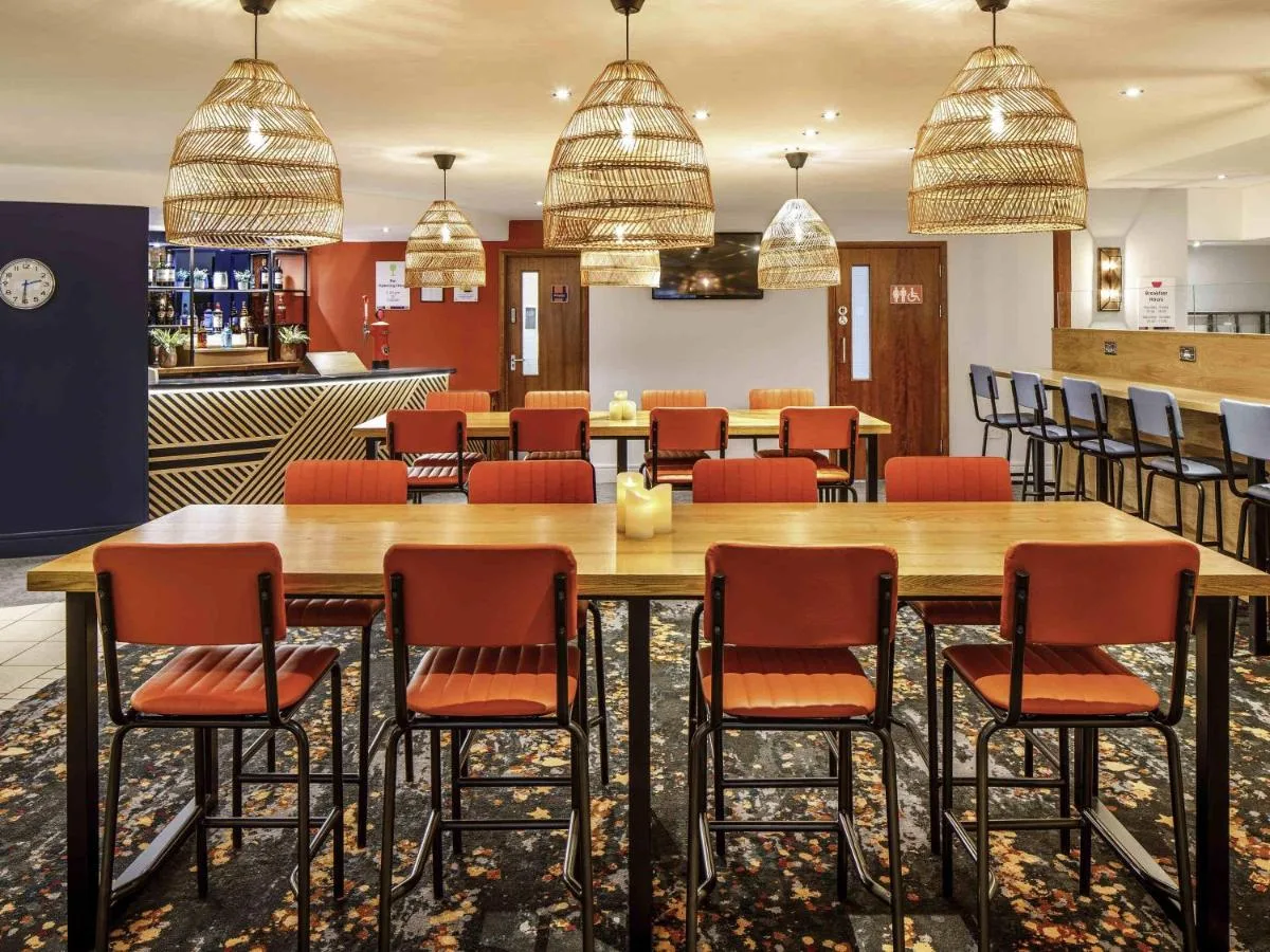 a conference room with a large wooden table and chairs at ibis Styles Birmingham Centre in Birmingham