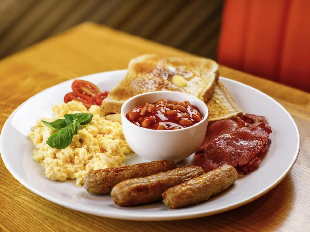 a plate of breakfast food with eggs sausage and toast at ibis Styles Birmingham Centre in Birmingham